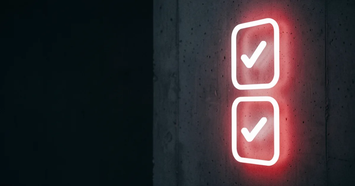 Two glowing neon checkboxes with checkmarks stacked on a dark concrete wall